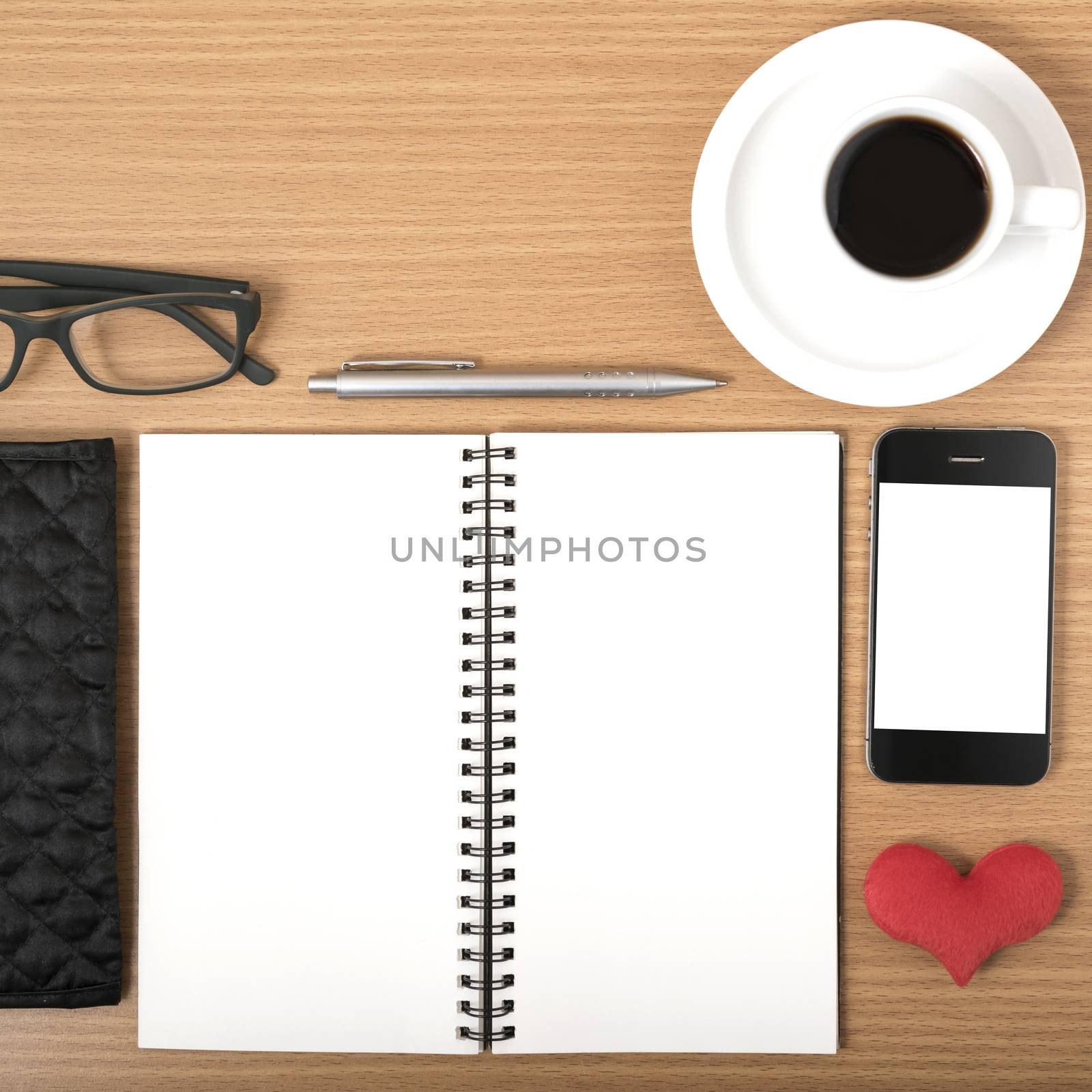 office desk : coffee with phone,notepad,eyeglasses,wallet,heart on wood background