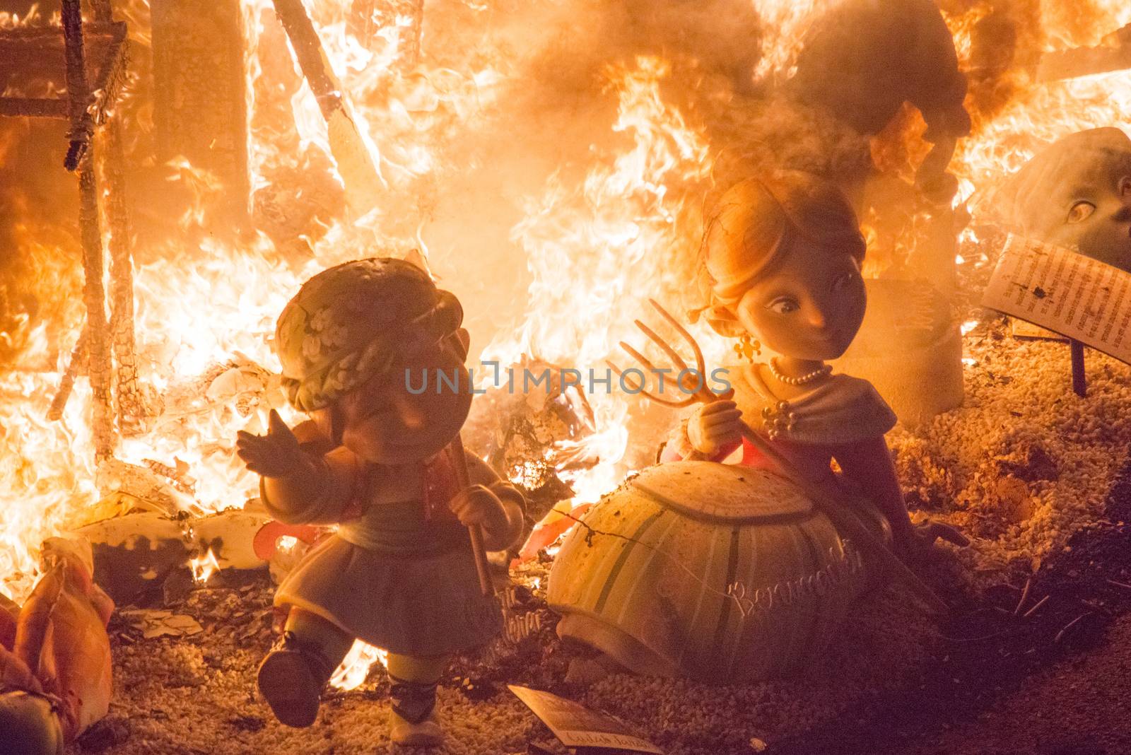 SPAIN, Valencia : Ninots burn on the last night of the Fallas Festival in Valencia on March 19, 2016.Fallas are gigantic structures made of cardboard portraying current events and personalities in which individual figures or Ninots are placed. The Fallas are burnt in the streets of Valencia as a tribute to St Joseph, patron saint of the carpenters' guild. 