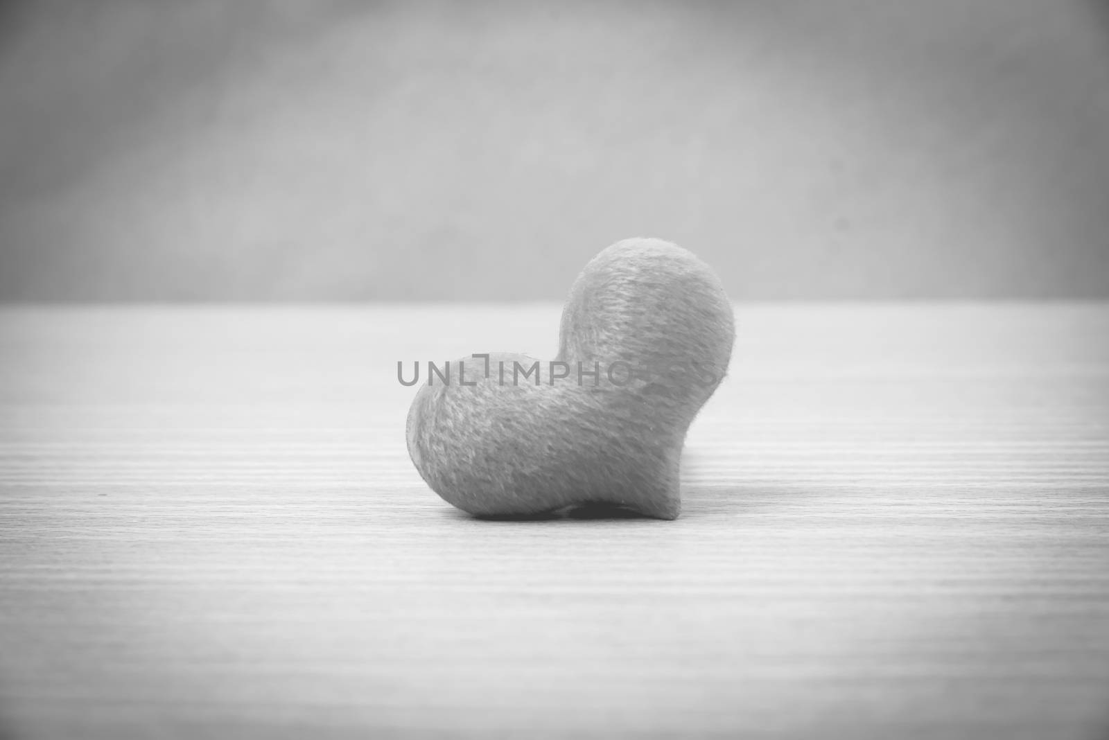 red heart on wood table background black and white color