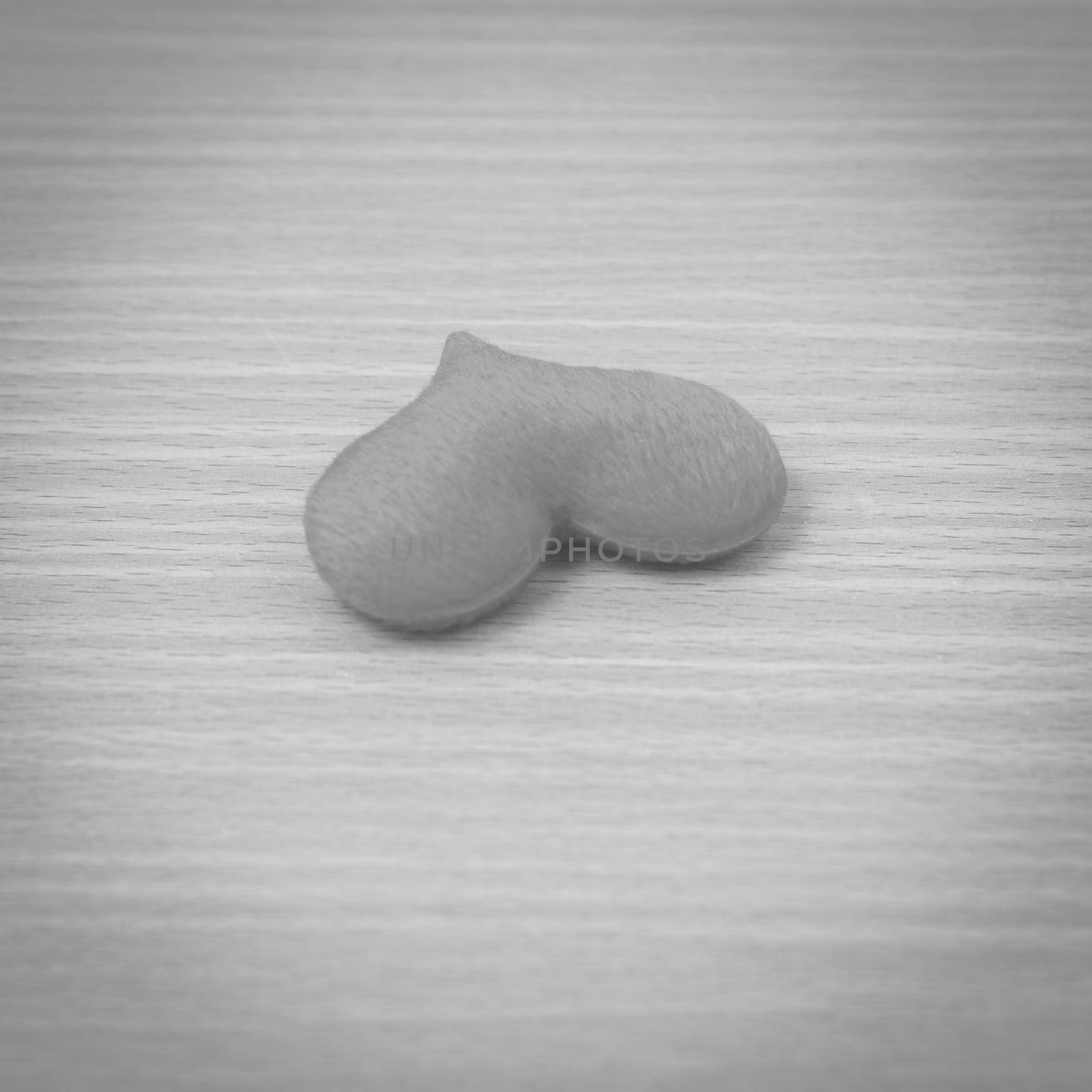 red heart on wood table background black and white color