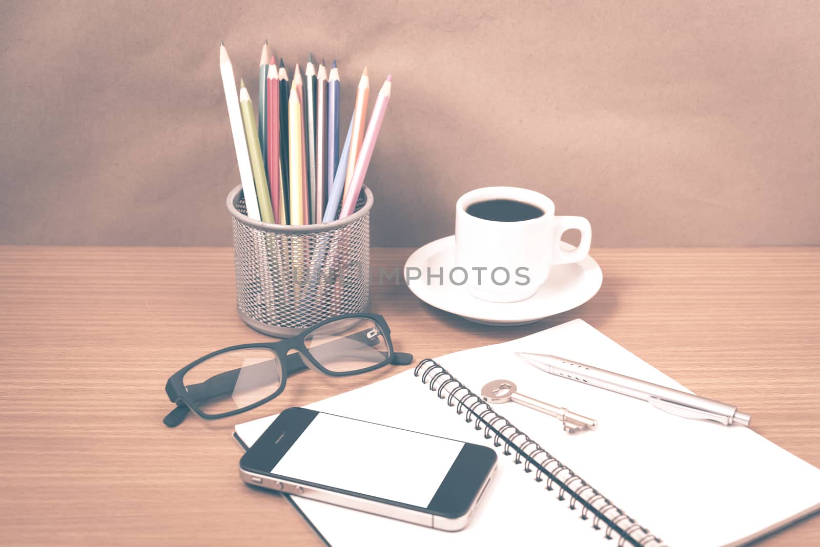 office desk : coffee and phone with key,eyeglasses,notepad,pencil box vintage style