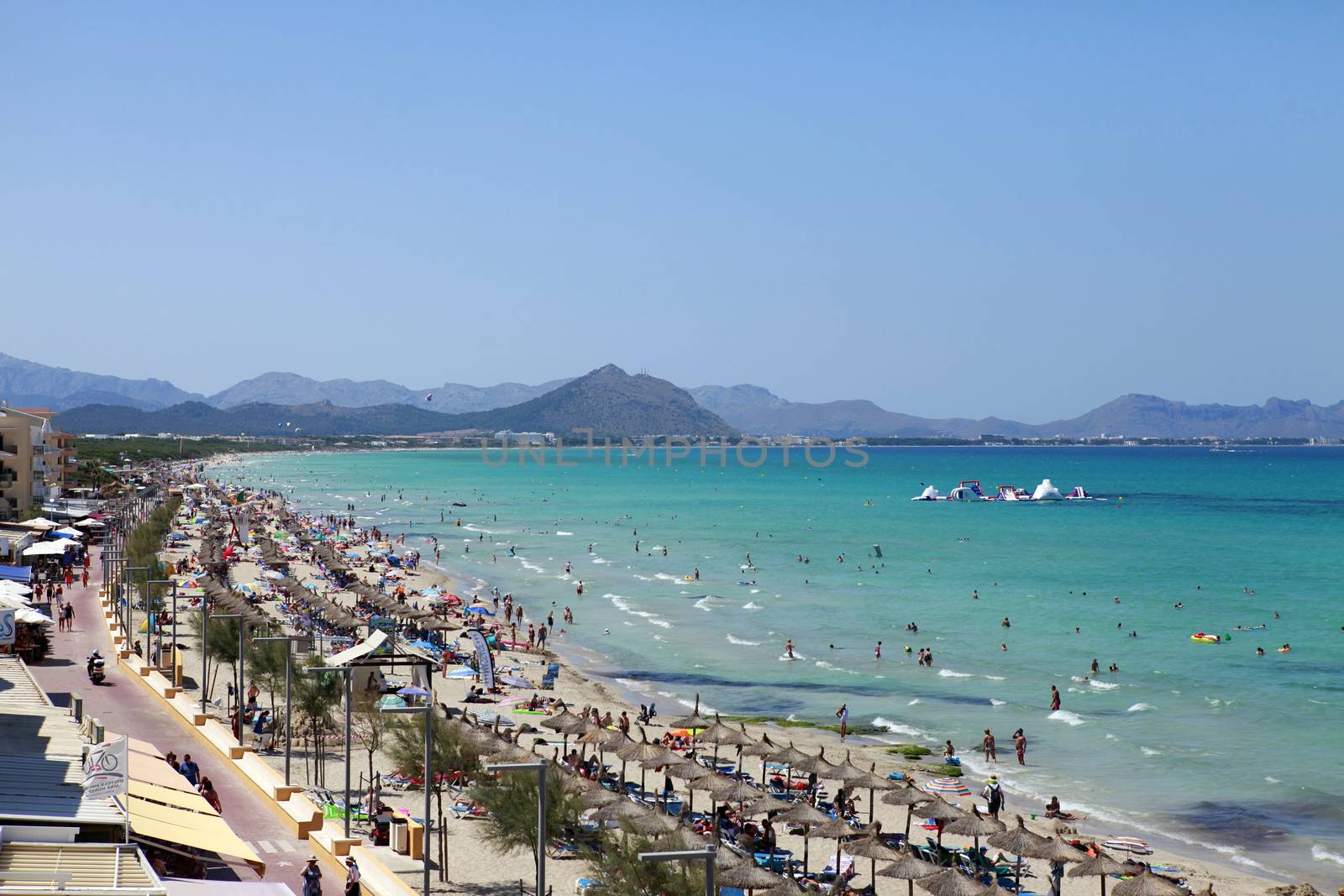 Mallorca, Spain - June 29, 2015: The tourists enjoiying their vacation on the beach. Up to 60 mln tourists is expected to visit Spain in year 2015.