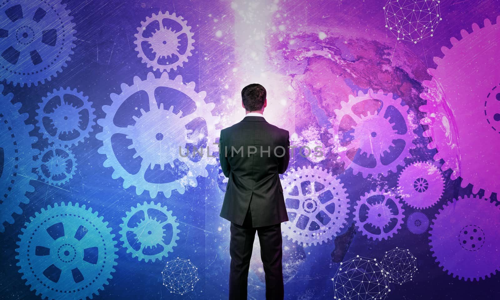 Businessman in front of holographic screen with earth globe and cog wheels. Elements of this image furnished by NASA