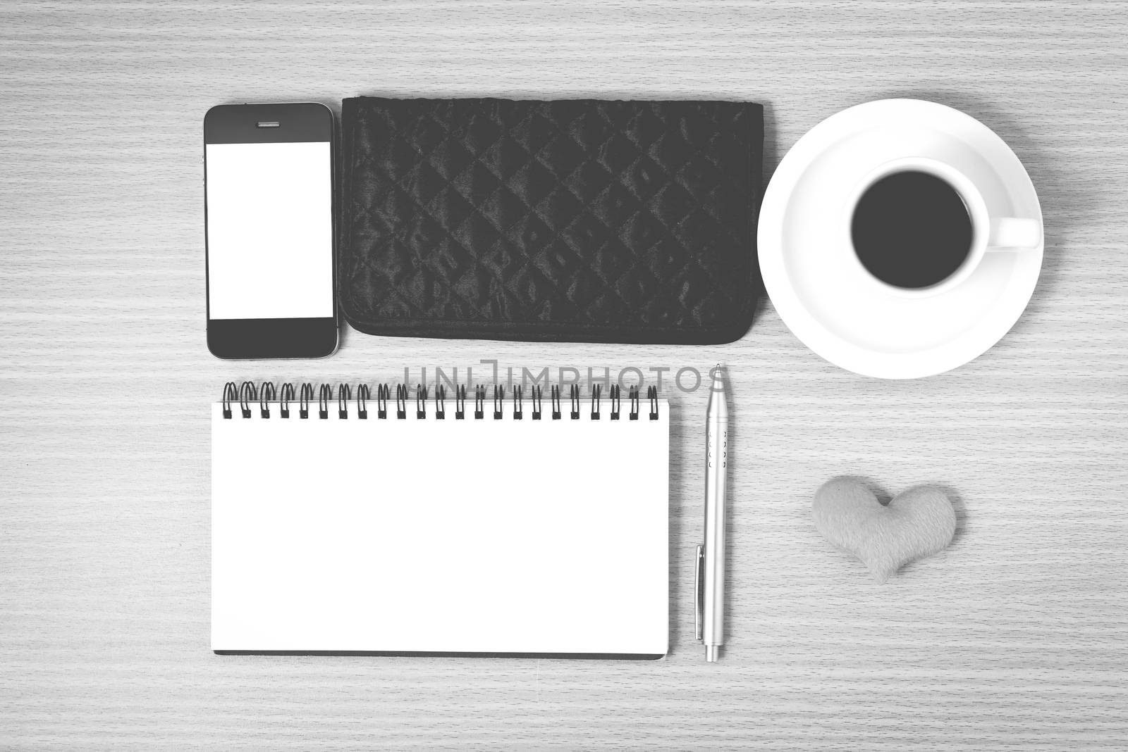 desktop : coffee with phone,notepad,wallet,heart on wood background black and white color