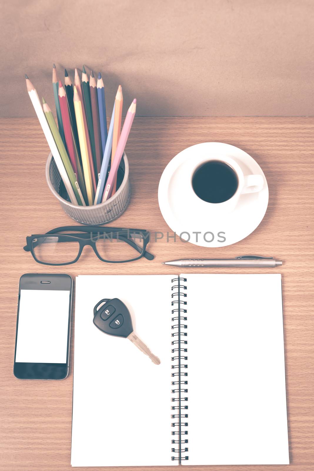 office desk : coffee and phone with key,eyeglasses,notepad,pencil box vintage style