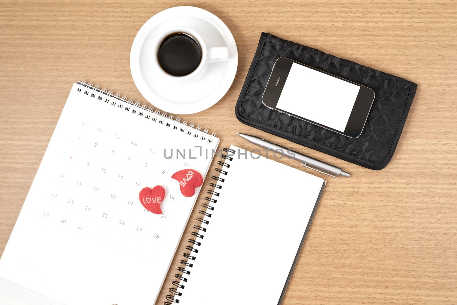 office desk : coffee with phone,wallet,calendar,heart,notepad on wood background