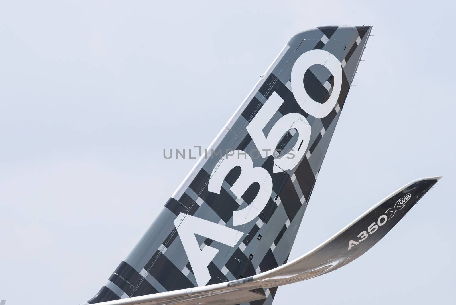 Singapore - February 17, 2016: Tailplane and winglet of an Airbus A350 XWB in Airbus factory livery during Singapore Airshow at Changi Exhibition Centre in Singapore.