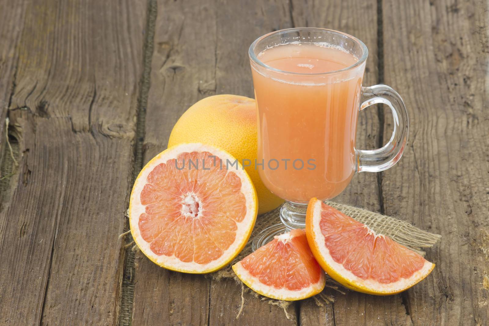 grapefruit juice and frish fruits on wooden background by miradrozdowski