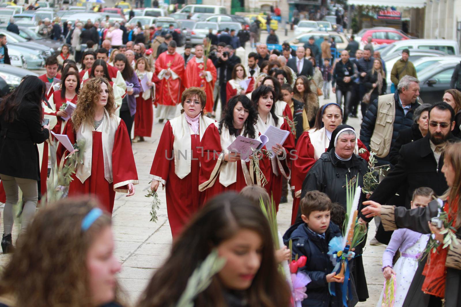 WEST BANK, Bethlehem: Palestinian Catholics walk to the Church of the Nativity Compound, to celebrate the Palm Sunday on March 20, 2016 in the West Bank city of Bethlehem. Palm Sunday marks the triumphant return of Jesus Christ to Jerusalem when a cheering crowd greeted him waving palm leaves, a week before his crucifixion.