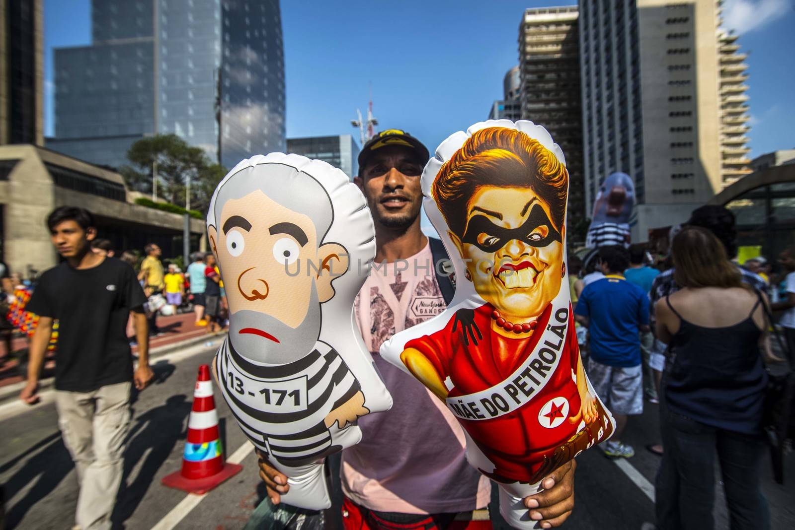 BRAZIL, Sao Paulo: A demonstrator holds balloon representing President Dilma Rousseff and former President Lula as thousands of protesters demonstrate against Brazilian former president (2003-2011) Luiz Inacio Lula da Silva in Sao Paulo, on March 20, 2016. Brazilian lawmakers relaunched impeachment proceedings against President Dilma Rousseff Thursday and a judge blocked her bid to bring her powerful predecessor into her cabinet, intensifying the political crisis engulfing her.