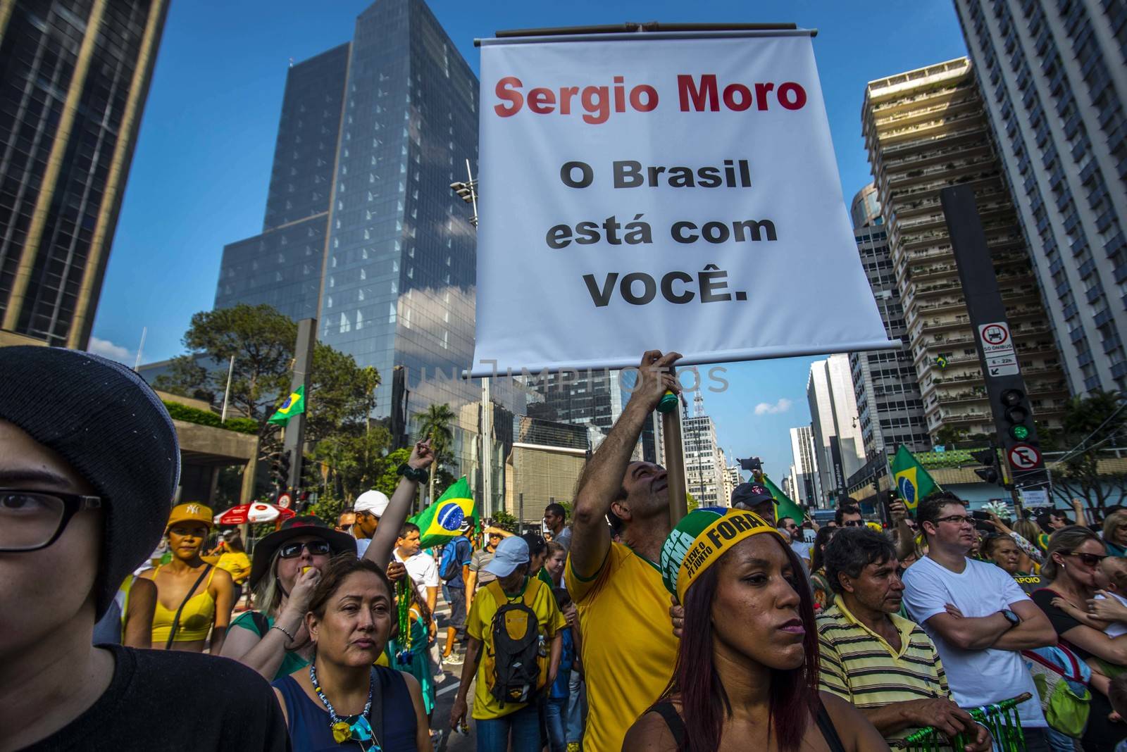 BRAZIL, Sao Paulo: A man holds a placard which reads 'Sergio Moro (judge): Brazil stands with you' as thousands of protesters demonstrate against Brazilian former president (2003-2011) Luiz Inacio Lula da Silva in Sao Paulo, on March 20, 2016. Brazilian lawmakers relaunched impeachment proceedings against President Dilma Rousseff Thursday and a judge blocked her bid to bring her powerful predecessor into her cabinet, intensifying the political crisis engulfing her.