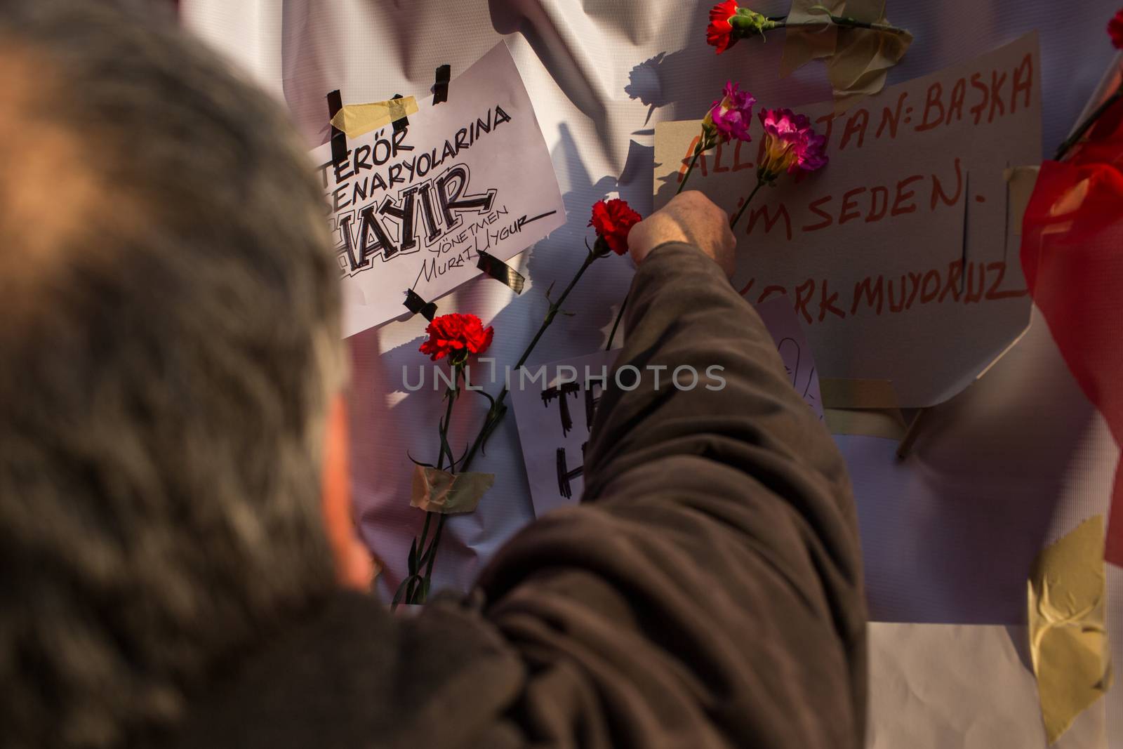 TURKEY, Istanbul: A man drops off a flower on the site of a blast on Istiklal Street, a major shopping and tourist district, in central Istanbul on March 20, 2016, to pay tribute to four people killed during a suicide blast that ripped through Istanbul less than a week after another deadly attack left 35 dead in Ankara.