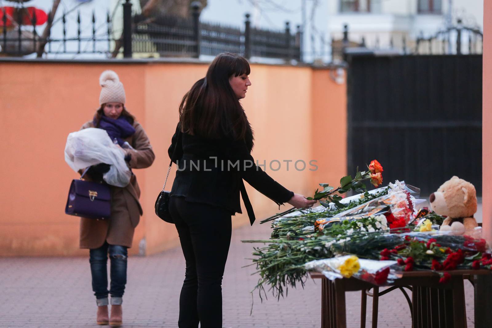 RUSSIA, Moscow: A woman drops off flowers pay tribute to Boeing-737-800 crash victims  at the Moscow representative office of Rostov-on-Don city, on March 20, 2016 where passenger plane Boeing-737-800 crashed at landing. The plane crashed in southern Russia early on March 19, killing all 62 people on board as it tried to land in bad weather in the city of Rostov-on-Don.