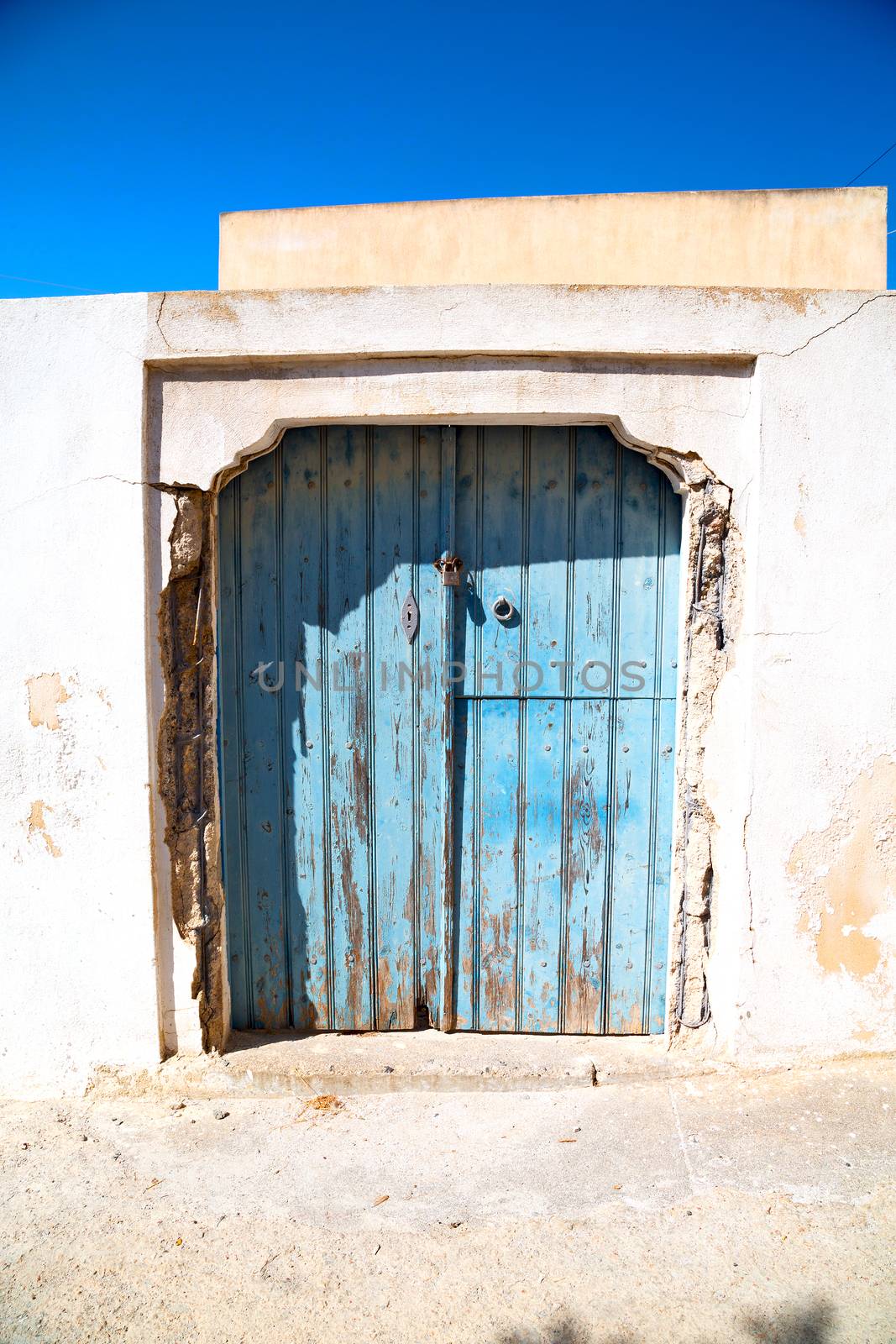 blue door in  village   white wall by lkpro