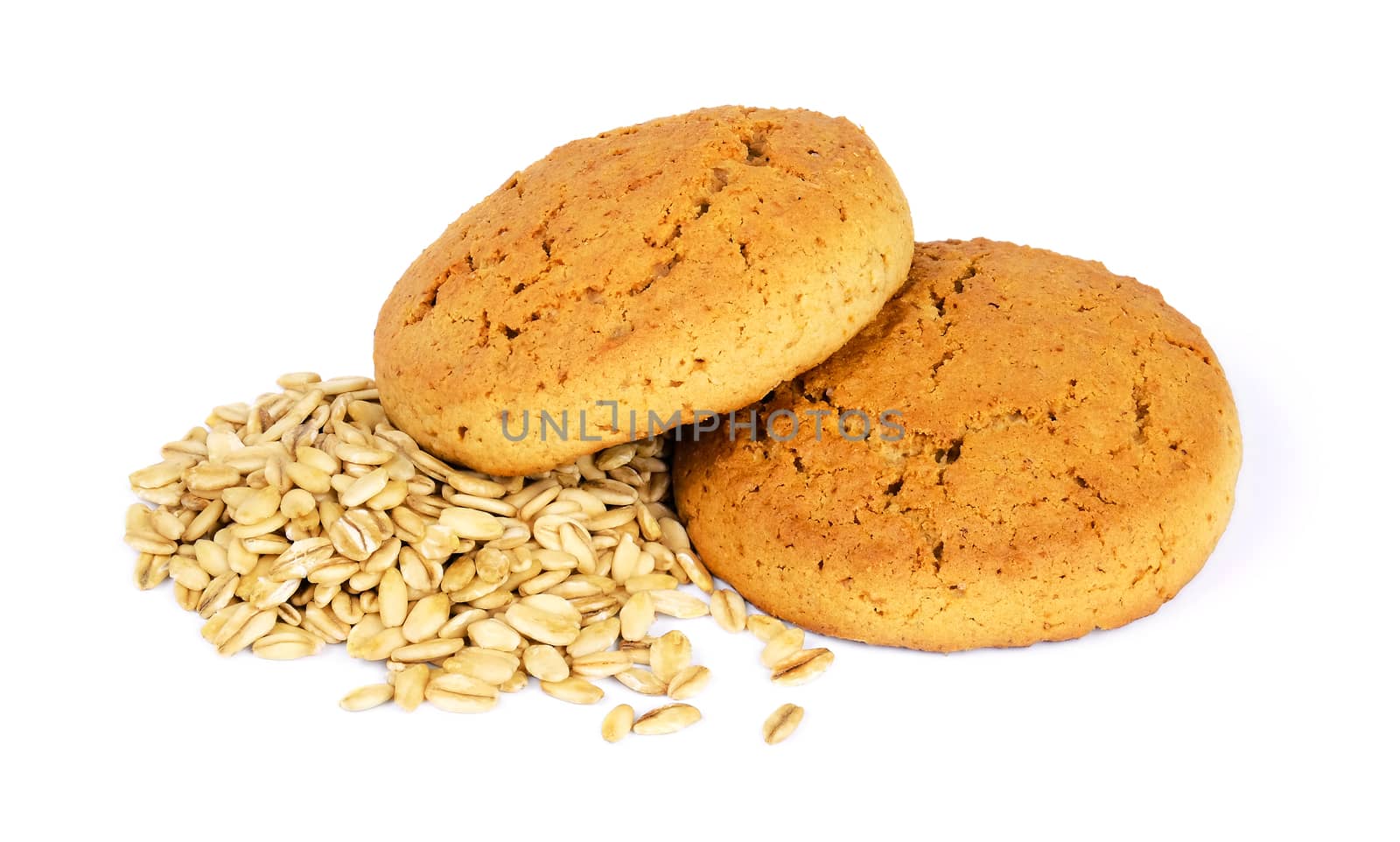 Two oatmeal cookies and scattered oat flakes, isolated on white background.