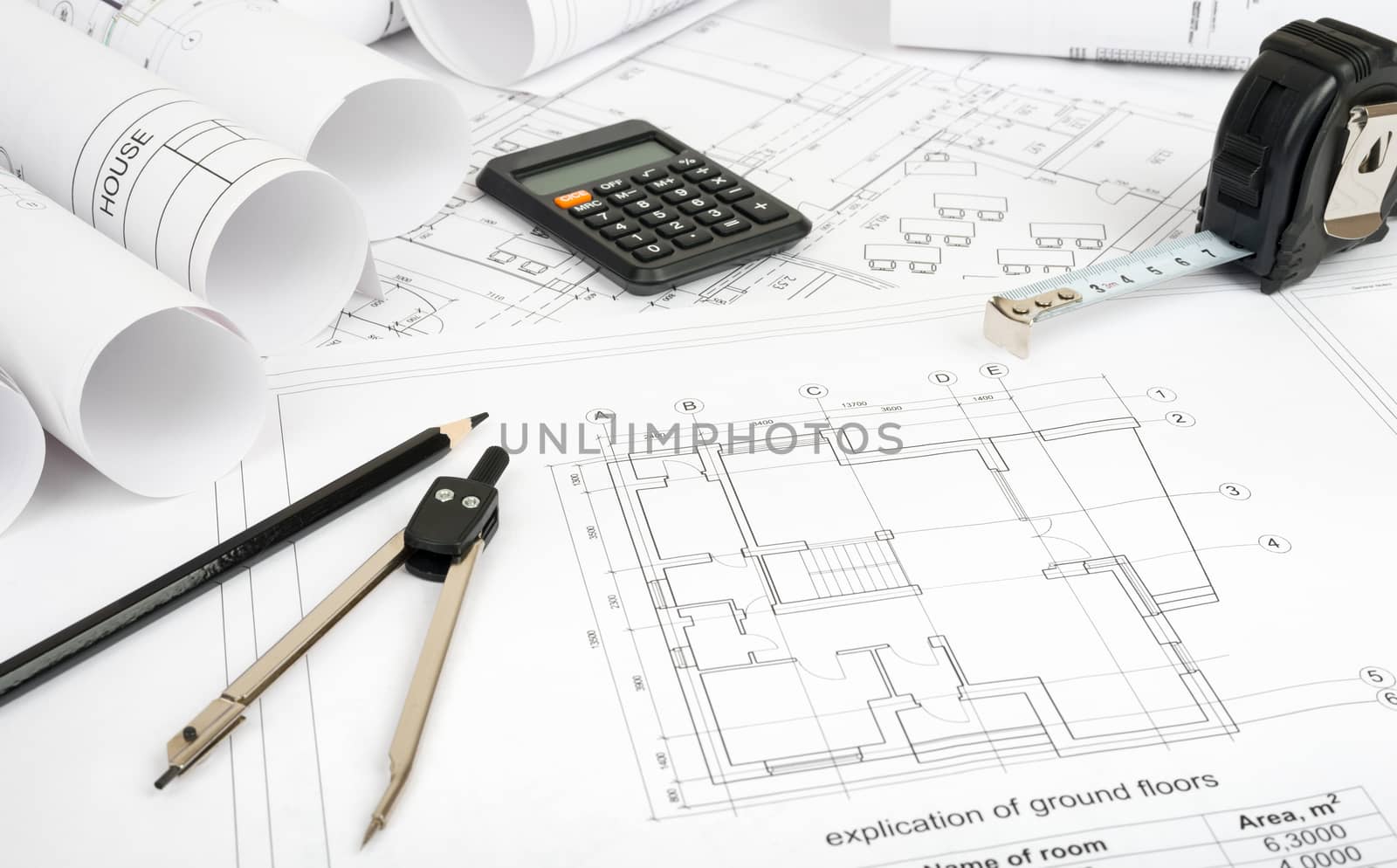 Architecture plan and rolls of blueprints with meter and calculator. Building concept