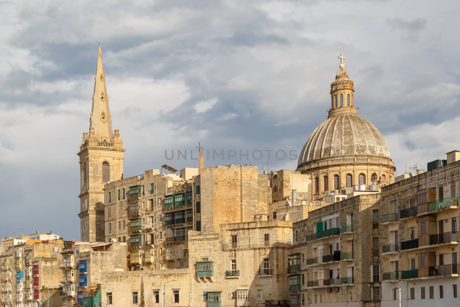 VALLETTA, MALTA - NOVEMBER 2, 2015 : View of Valletta with historical limestone buildings, on cloudy sky background.