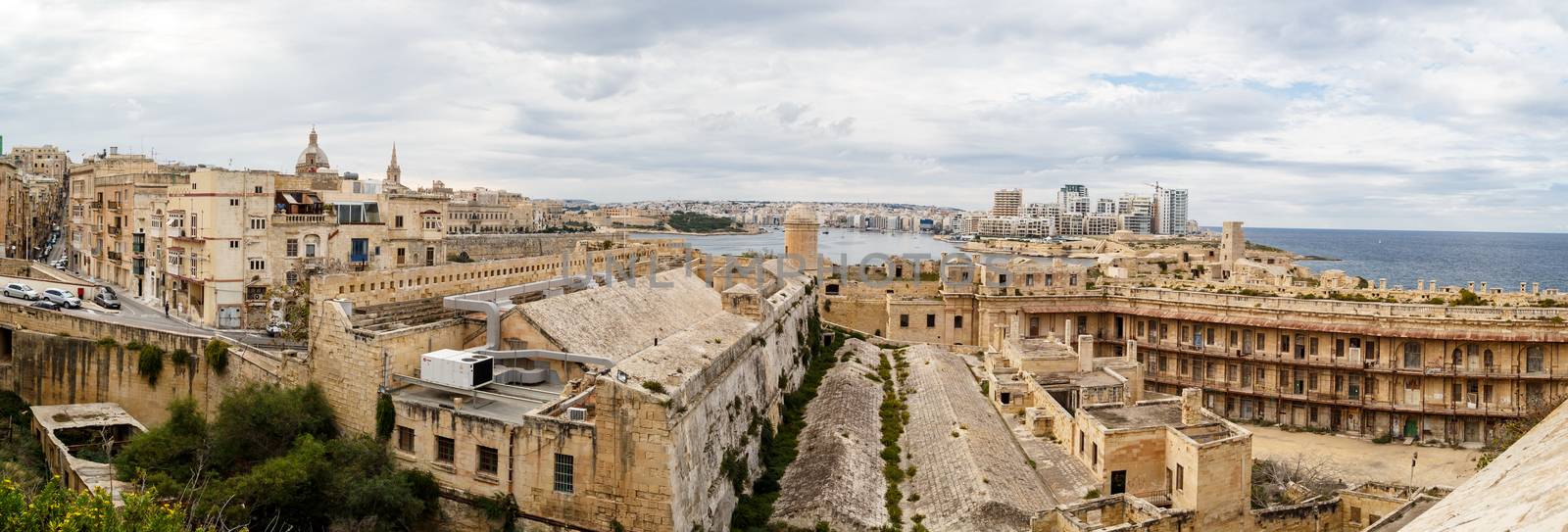 VALLETTA, MALTA - OCTOBER 30, 2015 : View of Valletta with historical limestone buildings, on cloudy sky background.