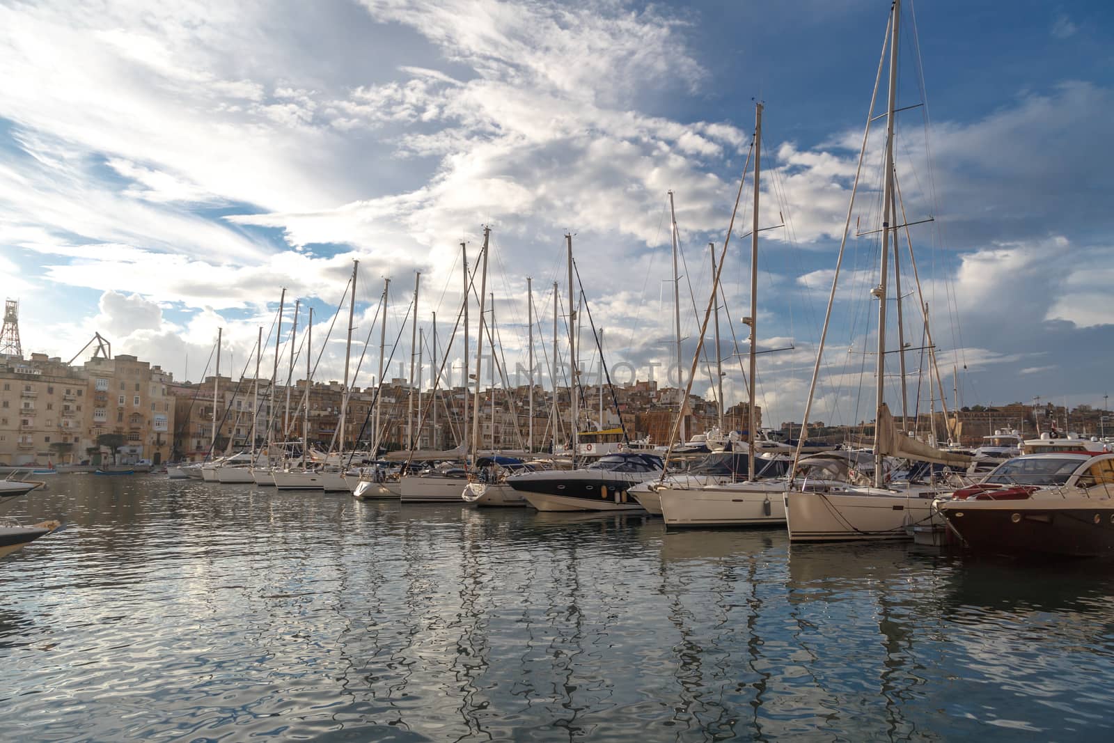 VALLETTA, MALTA - NPVEMBER 2, 2015 : View of Valletta marina with sailing boats, yatches and ships around, on cloudy sky background.