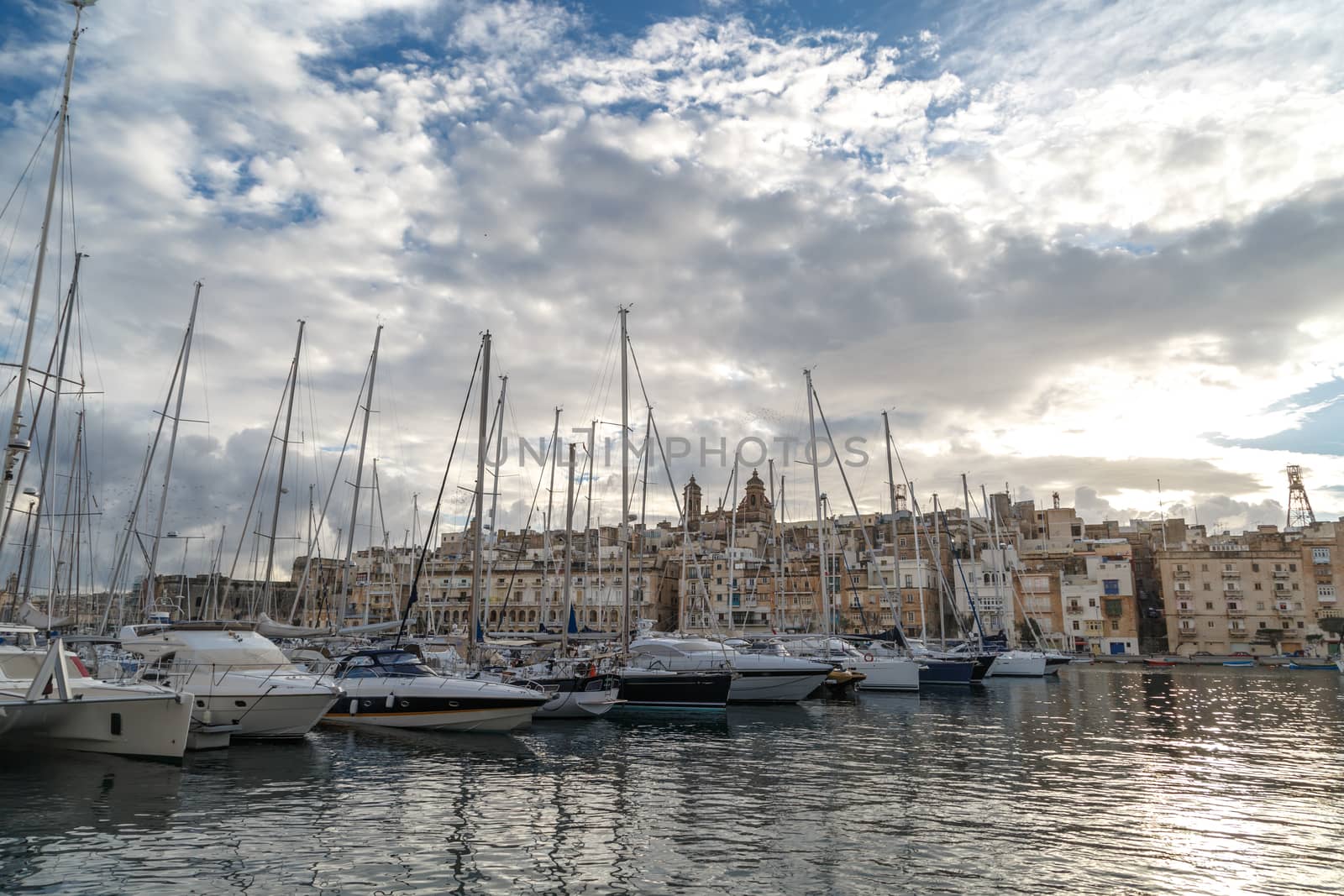 VALLETTA, MALTA - NPVEMBER 2, 2015 : View of Valletta marina with sailing boats, yatches and ships around, on cloudy sky background.
