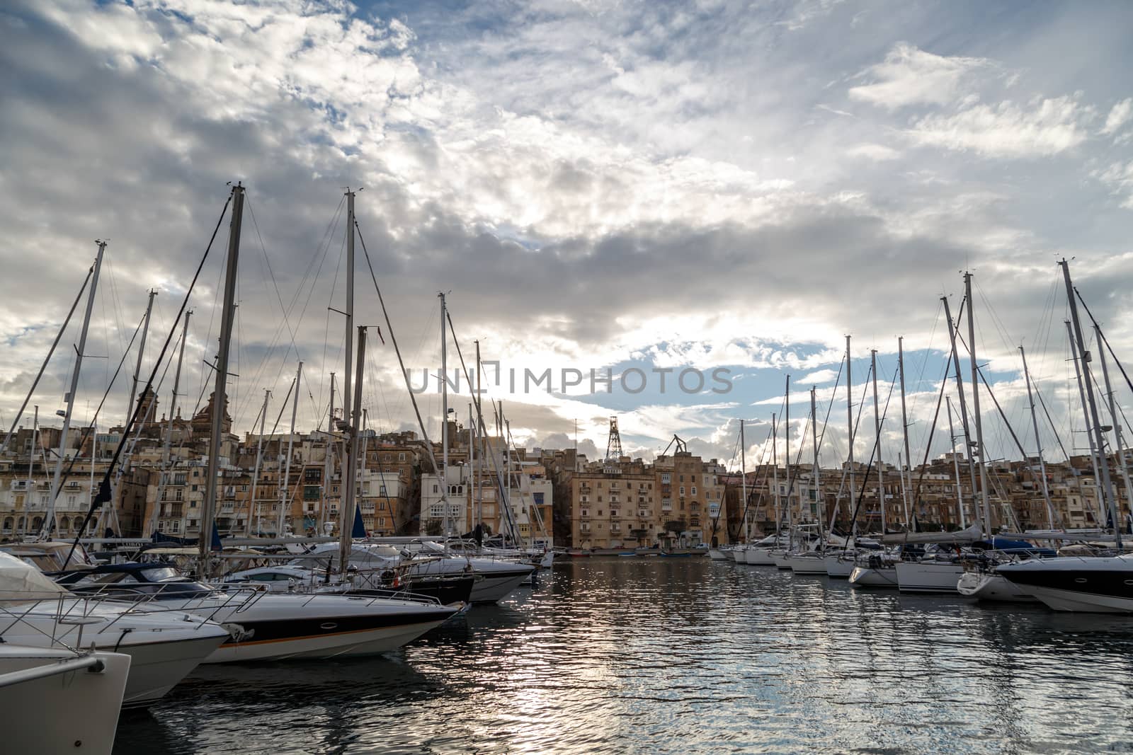 VALLETTA, MALTA - NPVEMBER 2, 2015 : View of Valletta marina with sailing boats, yatches and ships around, on cloudy sky background.