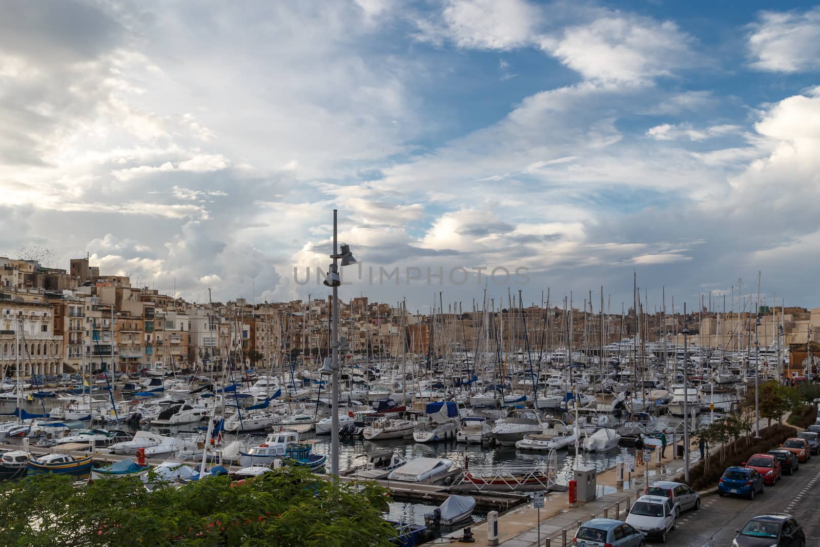 VALLETTA, MALTA - NPVEMBER 2, 2015 : View of Valletta marina with sailing boats, yatches and ships around, on cloudy sky background.