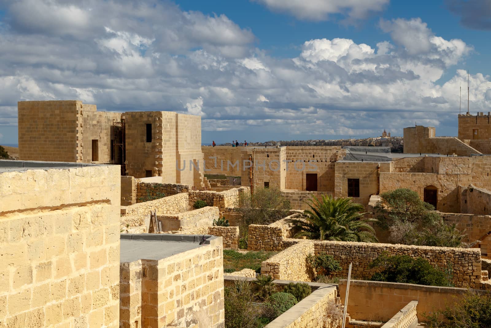 VICTORIA, MALTA - OCTOBER 31, 2015 : View of Cittadella, historical fortified small city of Cittadella with limestone structures, on cloudy blue sky background.