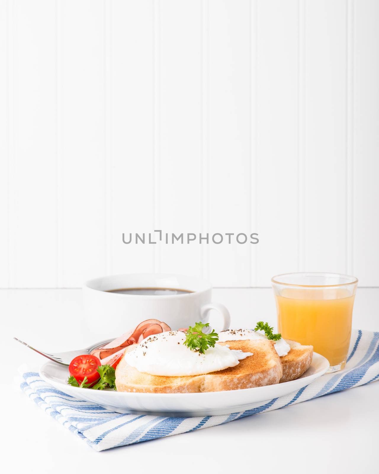 Perfectly poached eggs on toast with ham.