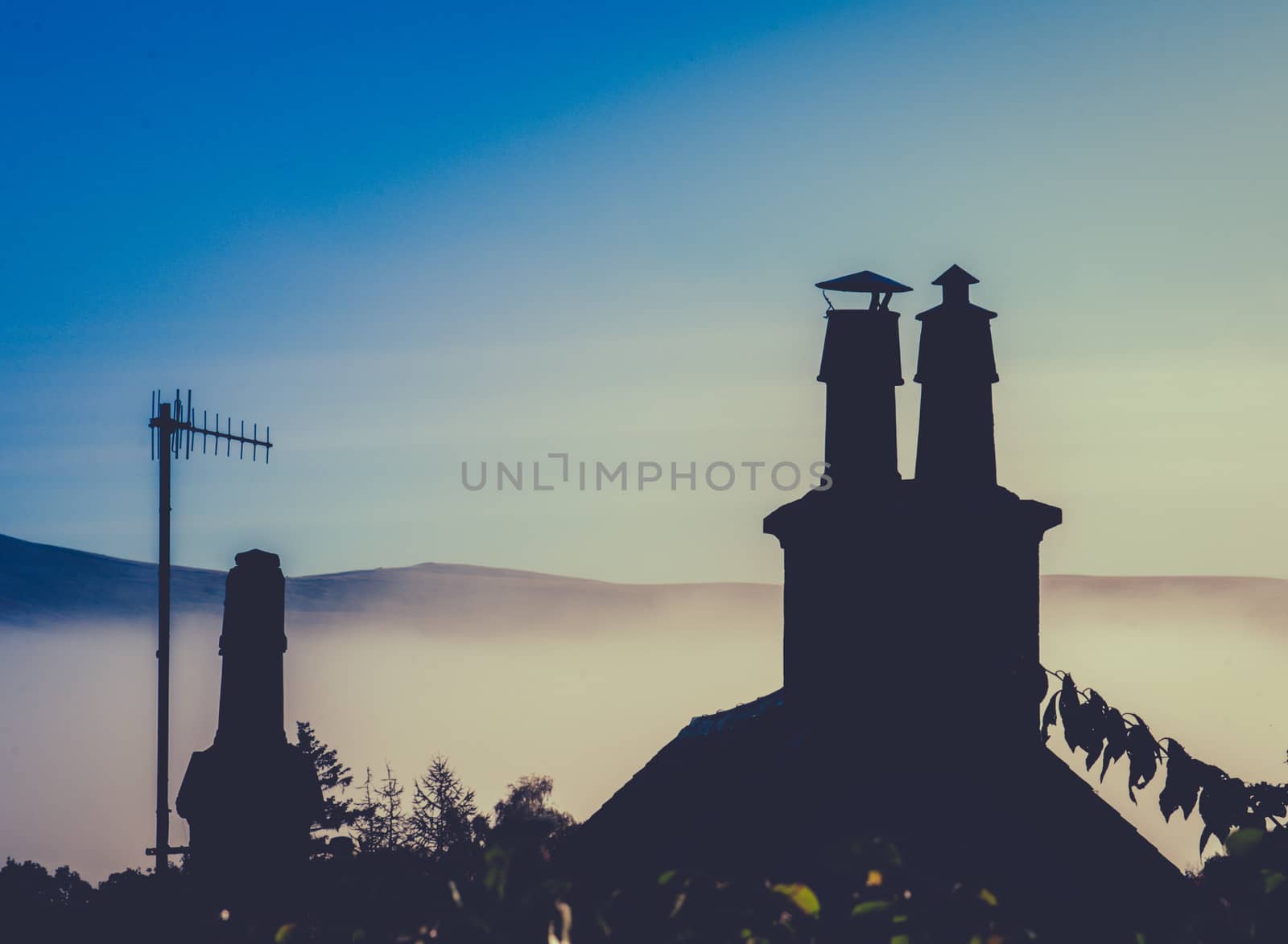 Rural Rooftop And Chimney Against Misty Dusk With Copy Space