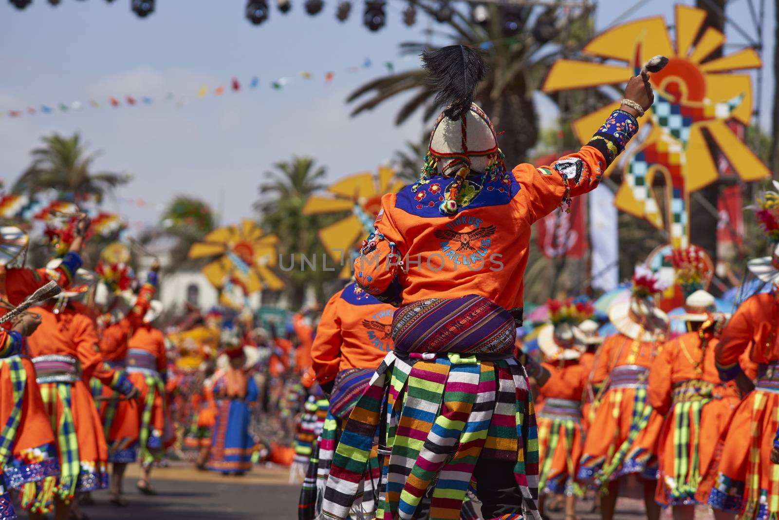 Tinku dancing group in colourful costumes performing a traditional ritual dance as part of the Carnaval Andino con la Fuerza del Sol in Arica, Chile.