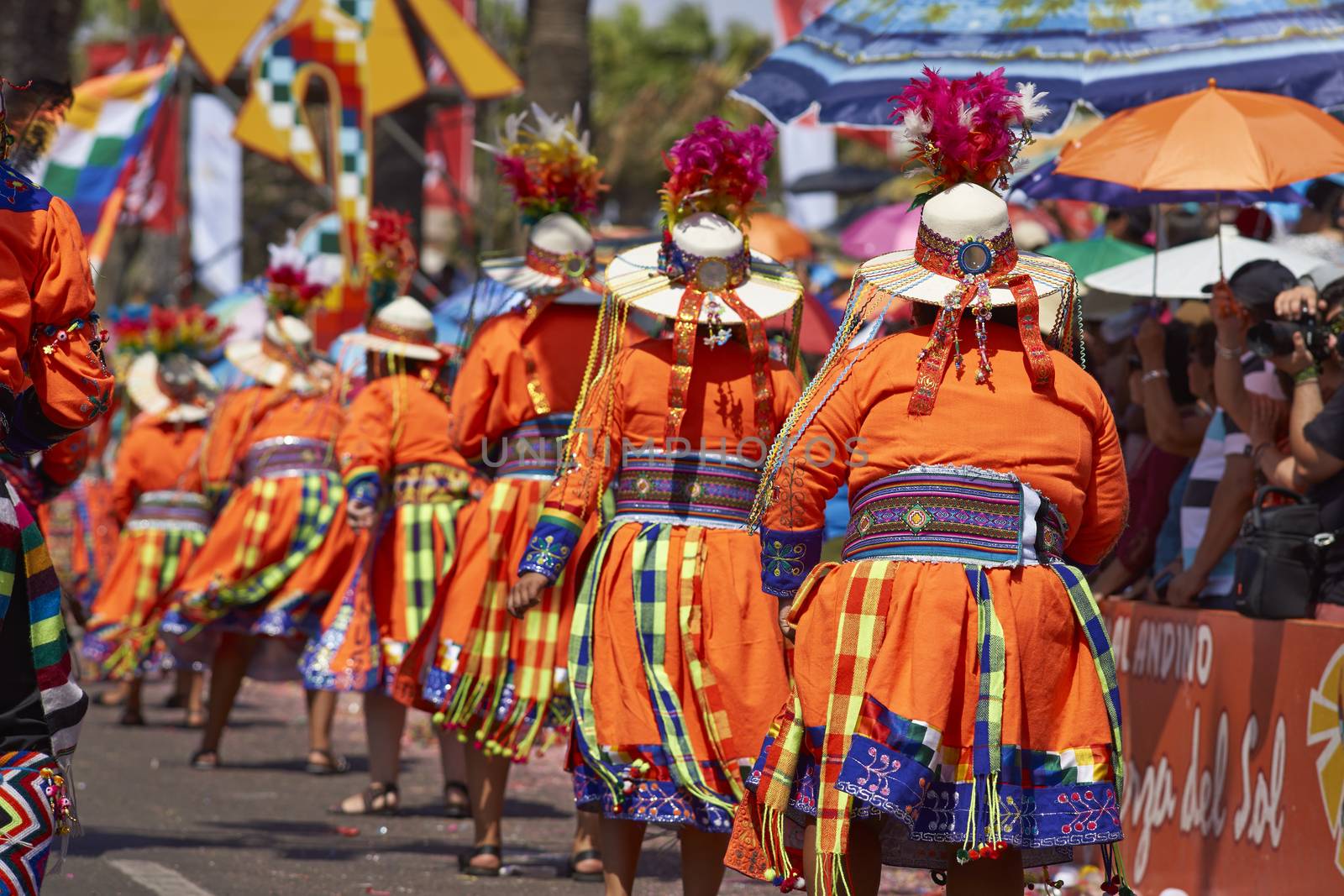 Tinku dancing group in colourful costumes performing a traditional ritual dance as part of the Carnaval Andino con la Fuerza del Sol in Arica, Chile.
