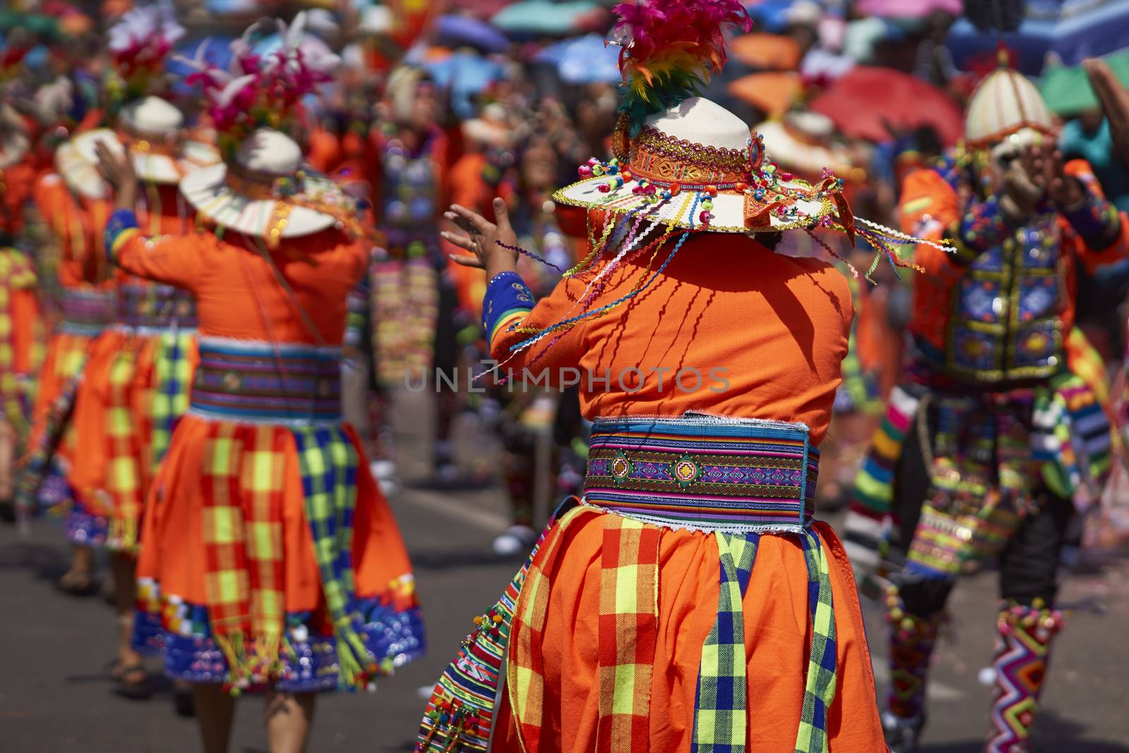 Tinku dancing group in colourful costumes performing a traditional ritual dance as part of the Carnaval Andino con la Fuerza del Sol in Arica, Chile.