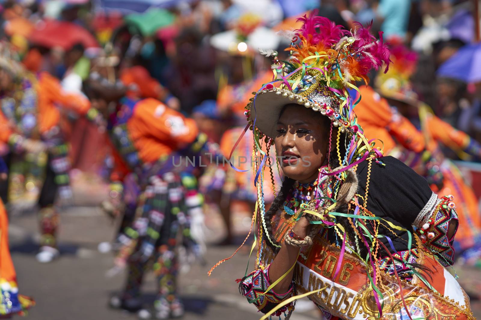 Tinku dancing group in colourful costumes performing a traditional ritual dance as part of the Carnaval Andino con la Fuerza del Sol in Arica, Chile.