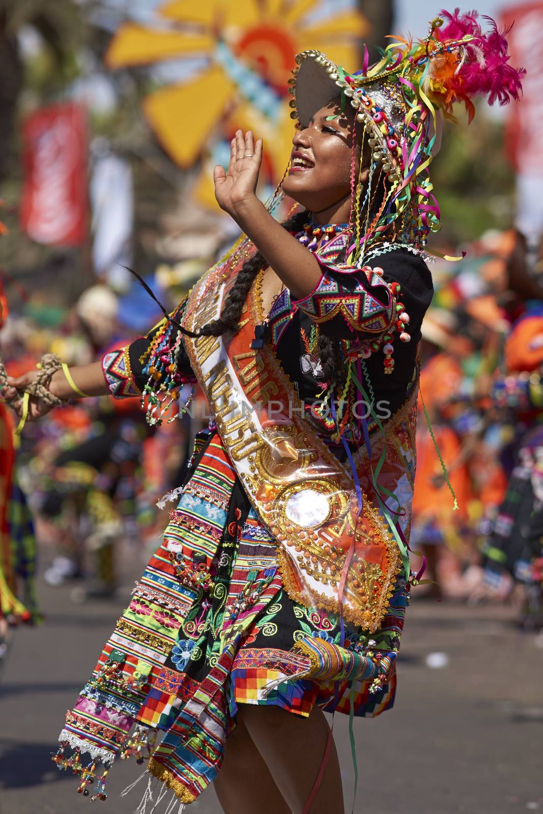 Tinku dancing group in colourful costumes performing a traditional ritual dance as part of the Carnaval Andino con la Fuerza del Sol in Arica, Chile.