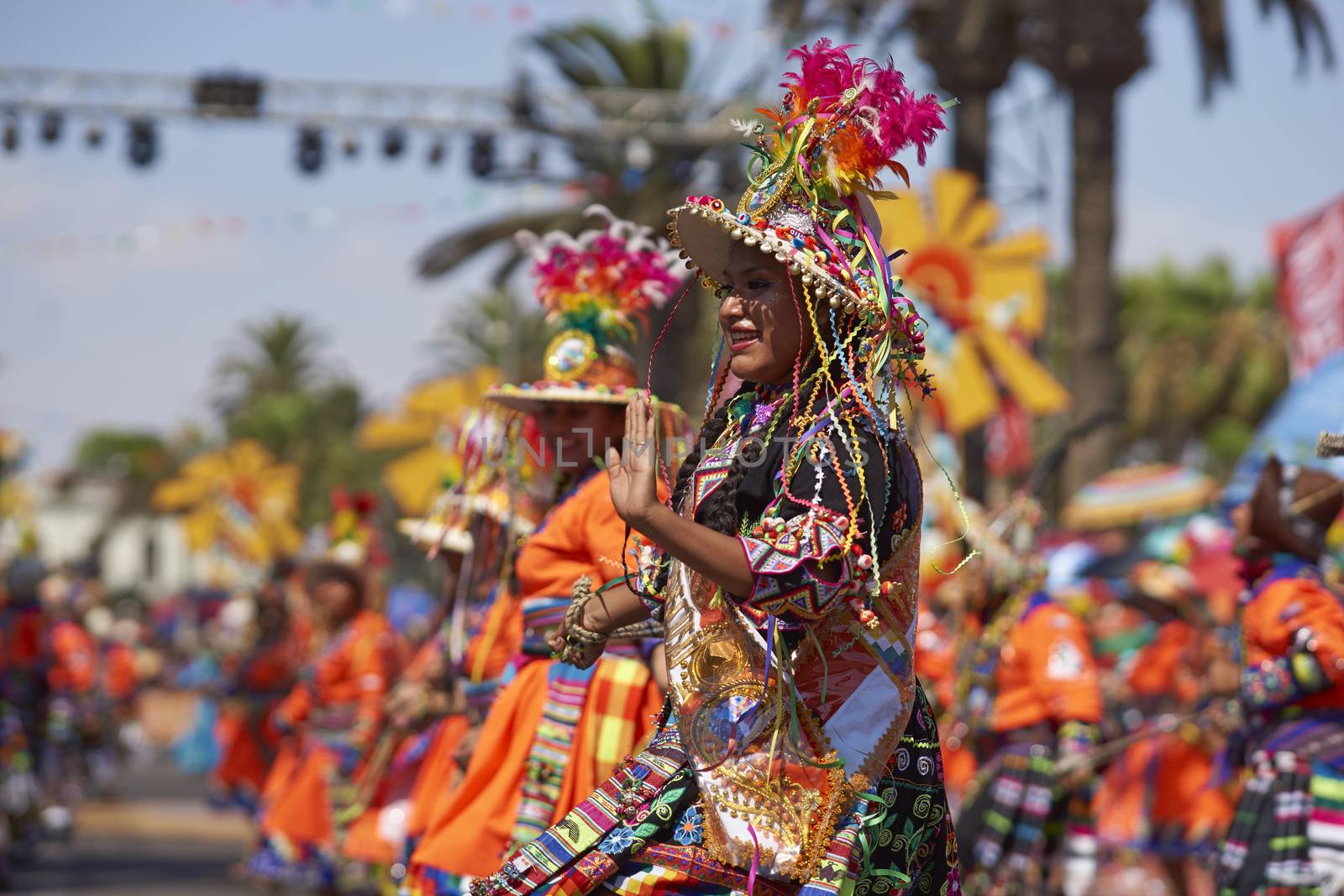 Tinku dancing group in colourful costumes performing a traditional ritual dance as part of the Carnaval Andino con la Fuerza del Sol in Arica, Chile.