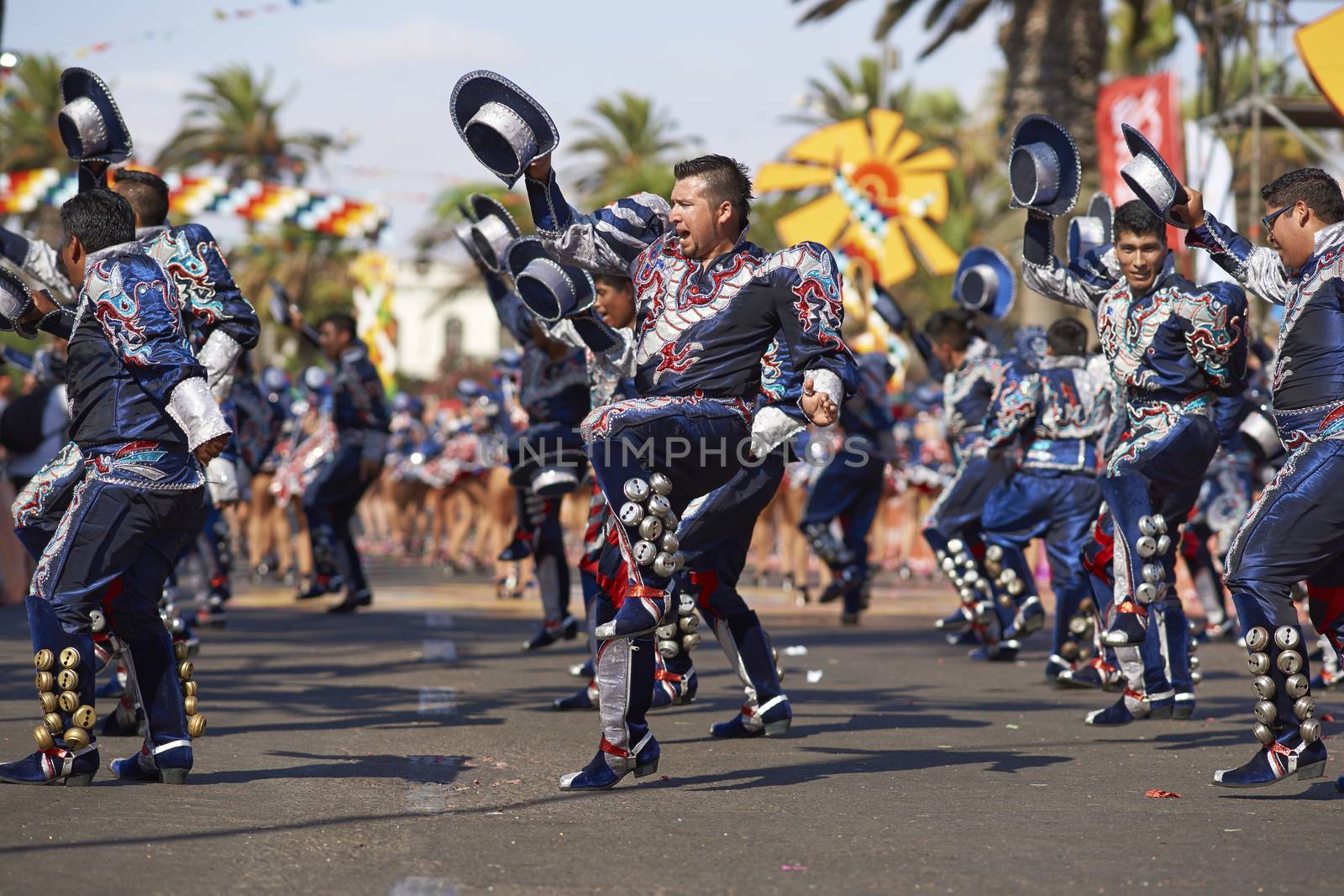 Caporales dance group in ornate costumes performing at the annual Carnaval Andino con la Fuerza del Sol in Arica, Chile.