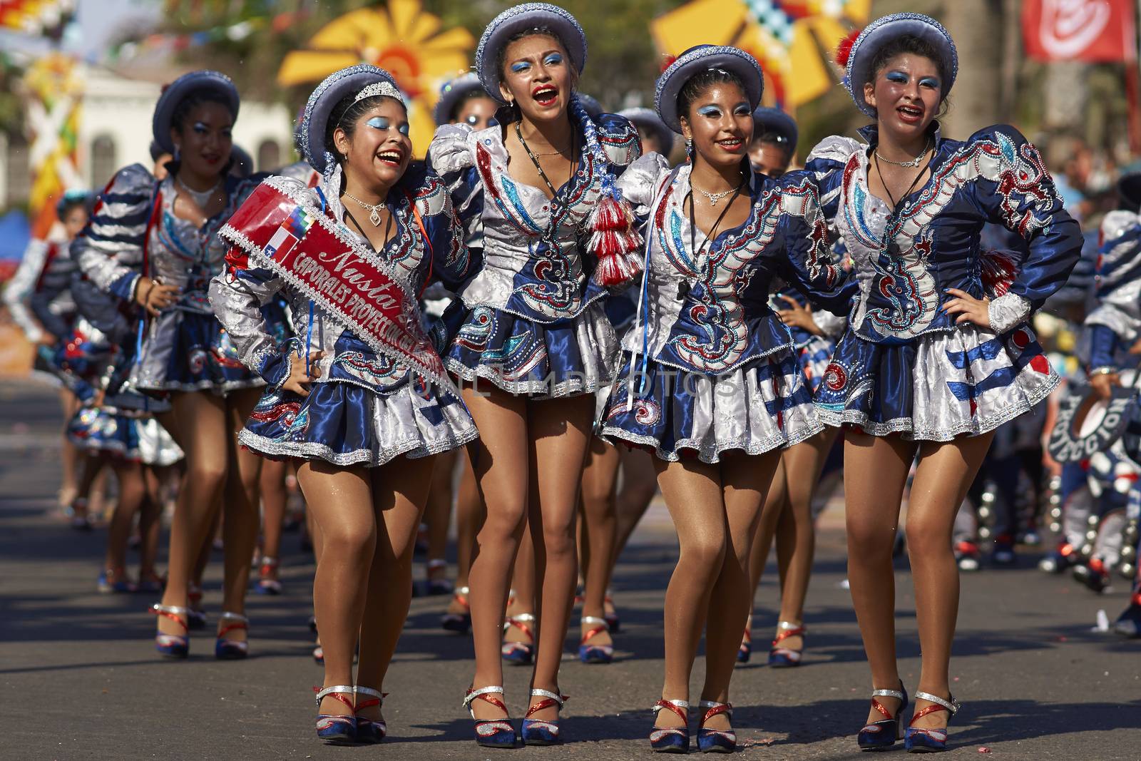 Female members of a Caporales dance group in ornate costumes performing at the annual Carnaval Andino con la Fuerza del Sol in Arica, Chile.