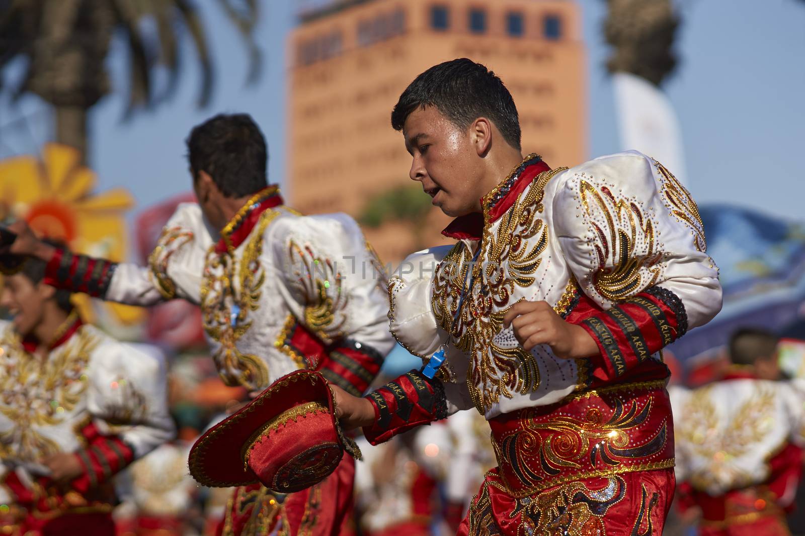Male Caporales dancers in ornate costumes performing at the annual Carnaval Andino con la Fuerza del Sol in Arica, Chile.