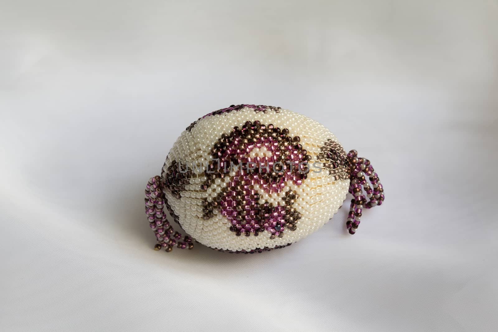 souvenir egg on delicate White silk background