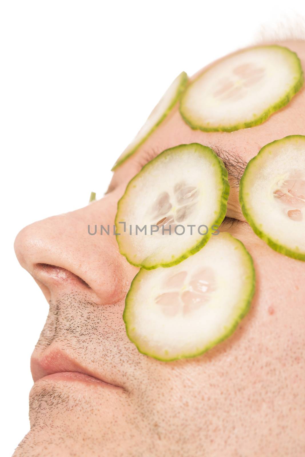 Man beauty care with cucumber by CatherineL-Prod