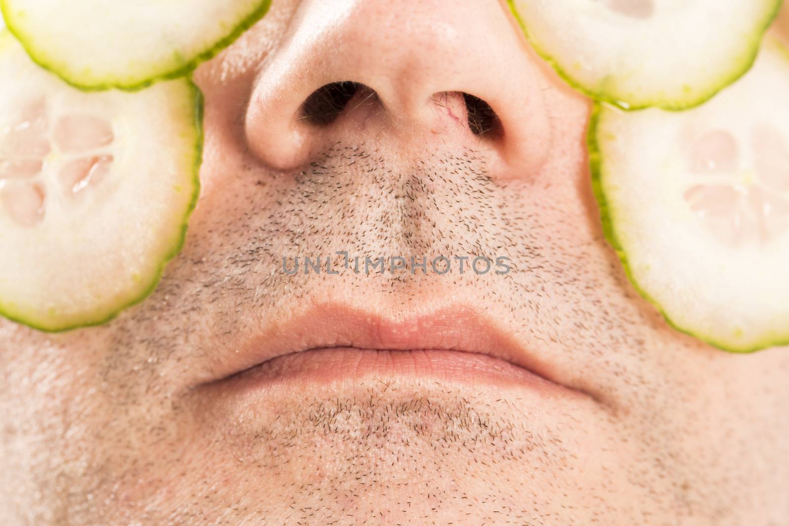 Close-up of mature man with face pack cucumber France