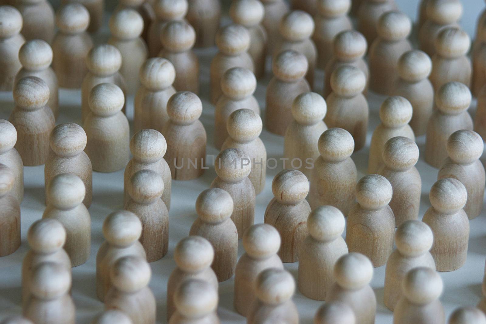 A group of wooden turned part people gathered together