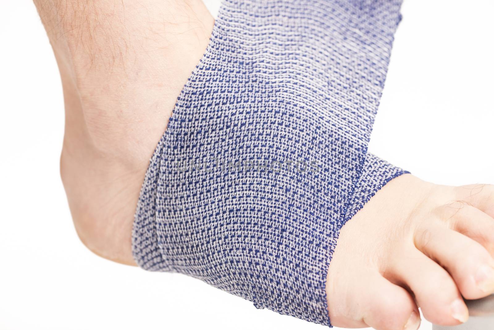 Man doing a bandage on foot ankle white background France
