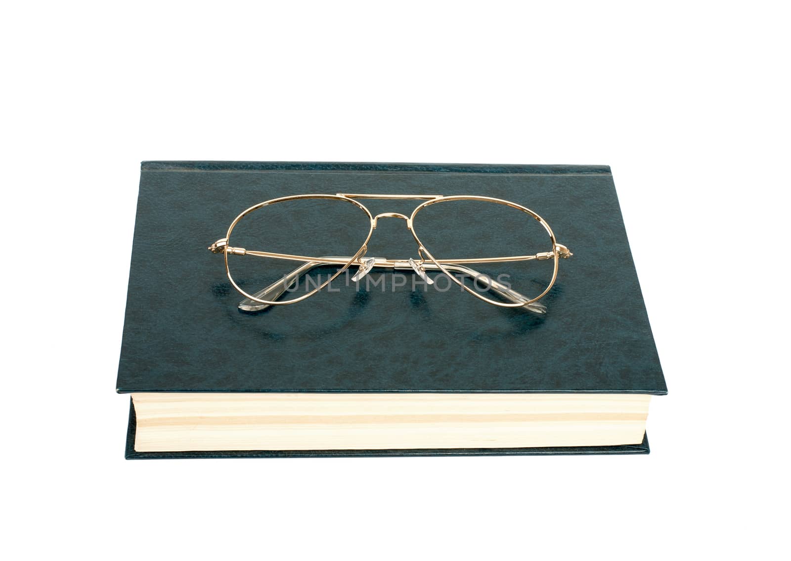 Closed book with glasses isolated on white background