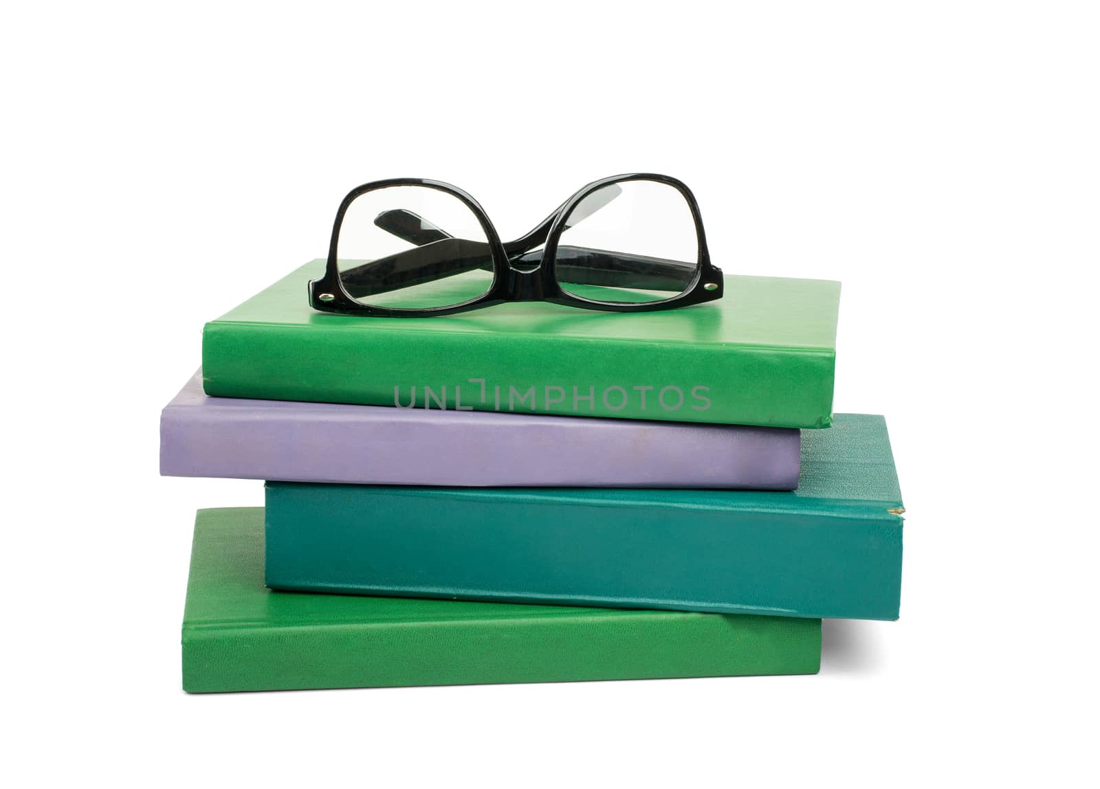 Pile of books with glasses isolated on white background, closeup