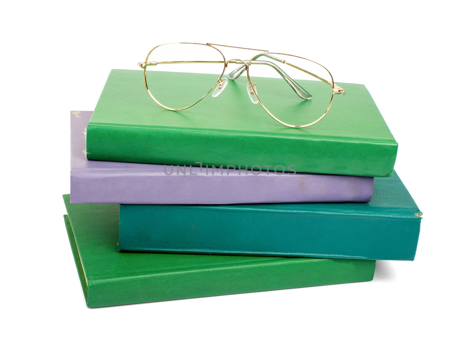 Pile of books with glasses isolated on white background