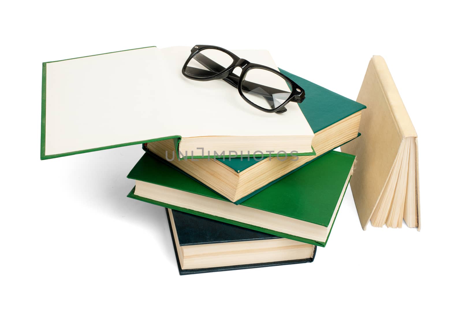 Pile of books with eyeglasses isolated on white background, closeup