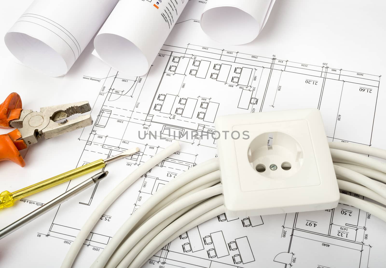 Architecture plan and rolls of blueprints with cable and socket. Building concept