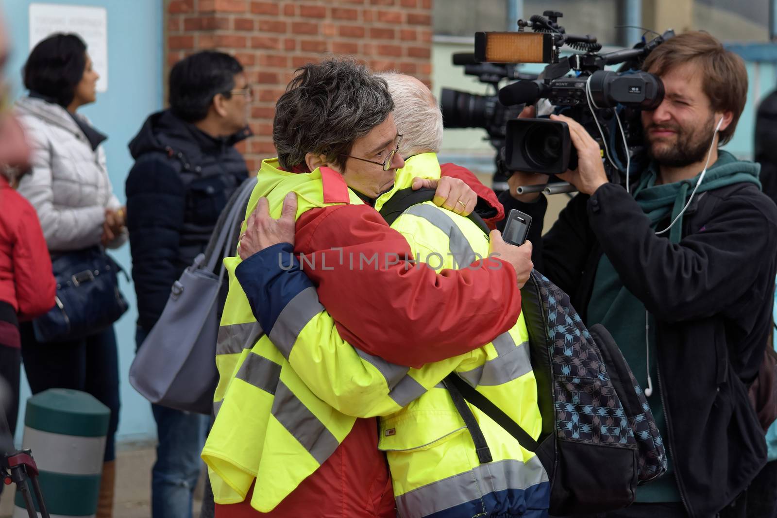 BELGIUM, Brussels: Passengers hold themselves in theirs arms outside Brussels international airport, on March 22, 2016 in Zaventem, following its evacuation after at least 13 people were killed and 35 injured as twin blasts rocked the main terminal of Brussels airport.