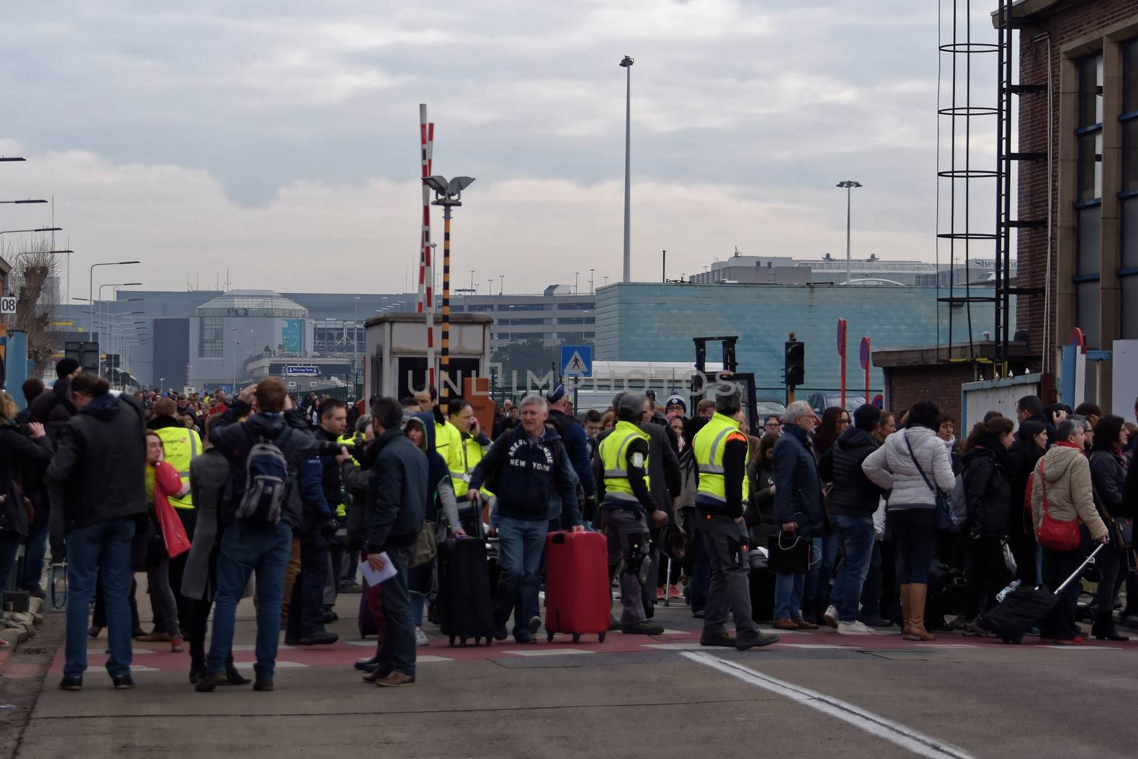 BELGIUM, Brussels: Passengers leave Brussels airport, on March 22, 2016 in Zaventem , following its evacuation after at least 13 people were killed and 35 injured as twin blasts rocked the main terminal of Brussels airport.